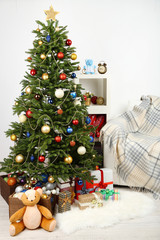 Decorated Christmas tree on home interior background
