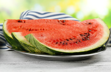 Fresh slice of watermelon on table outdoors, close up