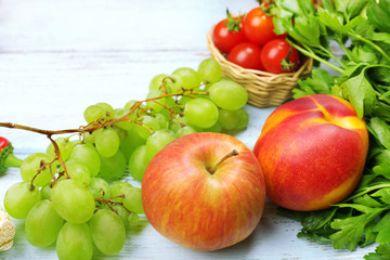 Fresh organic vegetables and fruits on wooden background