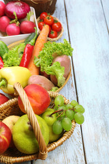 Fresh organic vegetables and fruits on wooden background