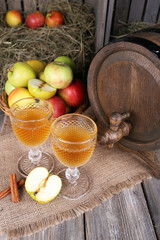 Still life with tasty apple cider in barrel and fresh apples