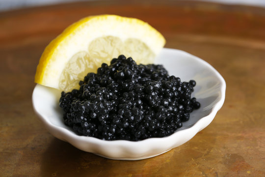 Black caviar and slice of lemon