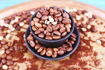 Coffee beans in cup on metal tray closeup