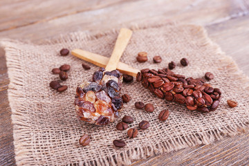 Spoons with coffee beans on sackcloth on blue wooden background