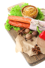 Smoked thin sausages, mustard in bowl and spices