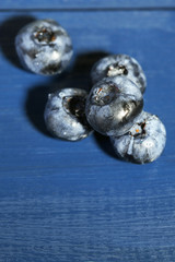 Tasty ripe blueberries, on wooden background