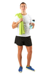 Handsome young sportsman holding towel and bottle with water