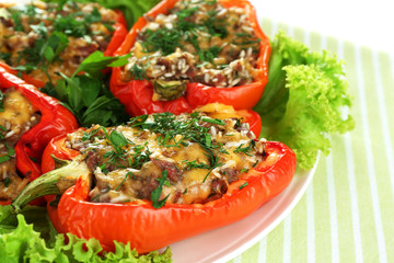 Stuffed red peppers on plate on napkin close up