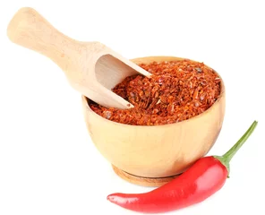 Poster Milled red chili pepper in wooden bowl isolated on white © Africa Studio