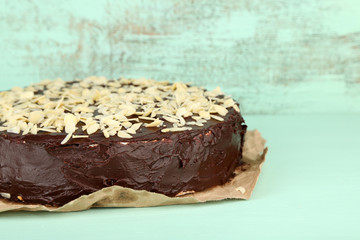 Tasty chocolate cake with almond, on old wooden table