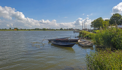 Row boats on the shore of a river