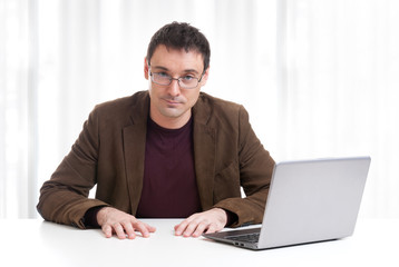 Happy man working on laptop