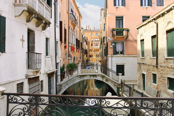 Fototapeta na wymiar Picturesque Italian houses on a narrow canal in Venice, Italy
