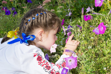 little girl smelling flowers