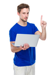 Caucasian man hold with laptop computer and finger point up