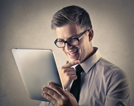 businessman who is looking something interesting in the tablet