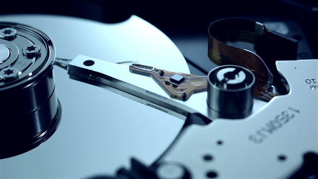 Dolly shot of hard disk drive with spinning platter