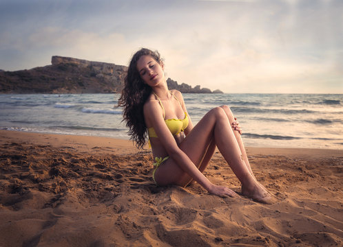beautiful woman sitting on the beach