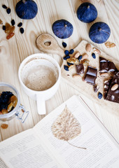cup of coffee with book and chocolate
