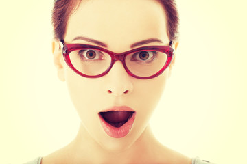 Young surprised woman in eyeglasses.