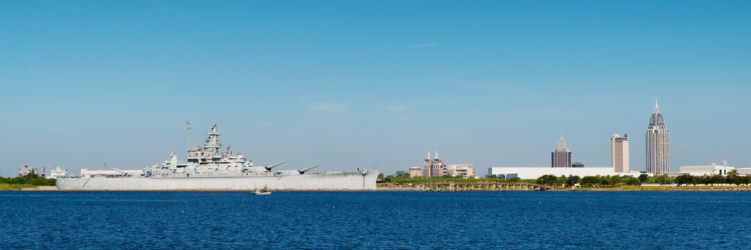Panoramic of Mobile, Alabama, skyline with U.S.S. Alabama in for