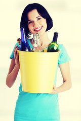 Beautiful young woman holding recycling bin