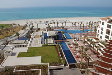 Luxury hotel pool and white sandy beach