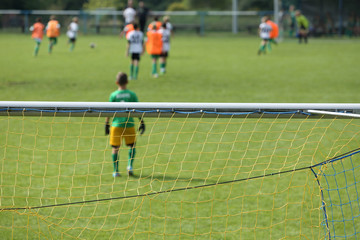 Young boys play football match