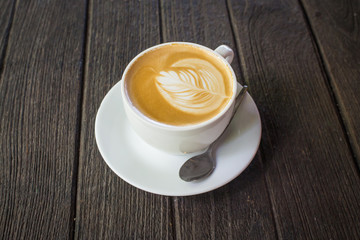 Cup of latte coffee on wood