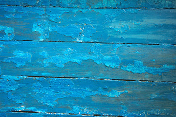 Fototapeta na wymiar blue wooden planks with peeling paint, texture