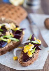 vegetarian sandwich with vegetables on a wooden background, clos
