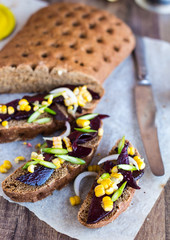 vegetarian sandwich with vegetables on a wooden background, clos