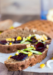 vegetarian sandwich with vegetables on a wooden background , ver