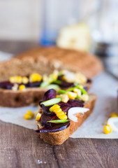 vegetarian sandwich with vegetables on a wooden background