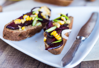 vegetarian sandwich with vegetables on white plate,horizontally