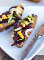 vegetarian sandwich with vegetables on white plate,knife