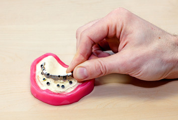 Designing Artificial Facial Dental on Wooden Table.