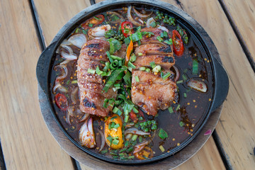 Top view of Thai Spicy grilled pork on hot plate
