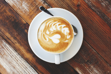 Coffee cup on wooden table, artistic photo