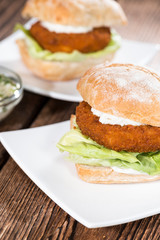 Homemade Fishburger on wooden background