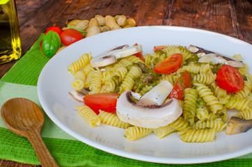 Pasta with basil pesto, nuts and mushrooms