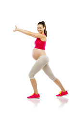 Pregnant fitness woman isolated on white
