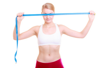 Fototapeta na wymiar Fitness girl fit woman covering her eyes with measuring tape