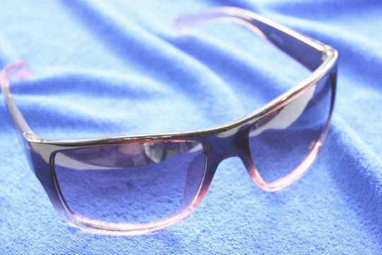 Women protection sunglasses  on blue  background.