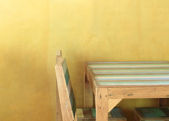 table wood in yellow room with mortar wall