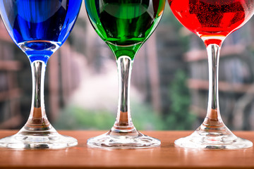 Glasses with blue red and green liquid cocktails