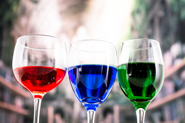 Glasses with blue red and green liquid cocktails