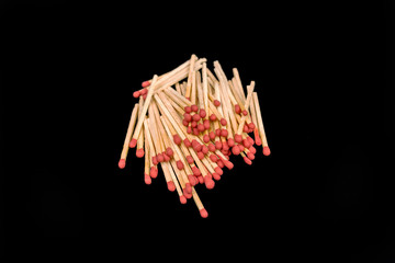 matchsticks stack up on black background