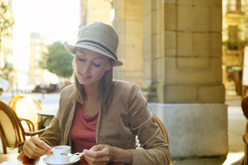 Young woman in the city sitting at coffee shop