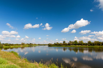 Fototapeta na wymiar River with reflection of clouds